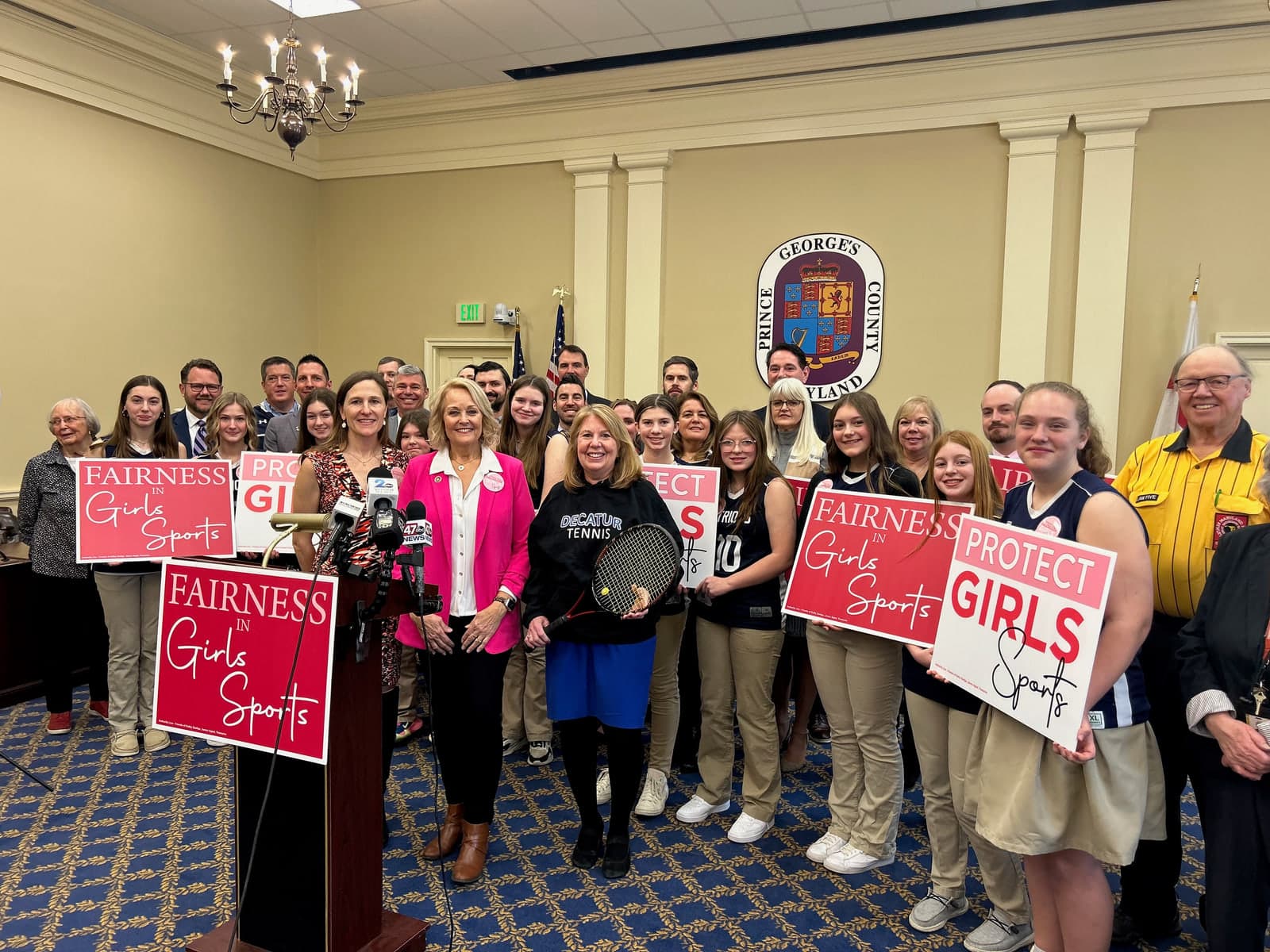 Kathy Szeliga and student athletes holding Fairness in Girls’ Sports signs at a press conference in Annapolis.