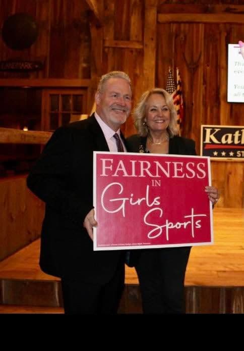 Kathy Szeliga holding a Fairness in Girls Sports sign at a campaign event.
