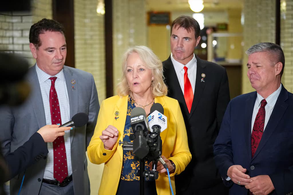 Kathy Szeliga answering reporters’ questions in a State House corridor.