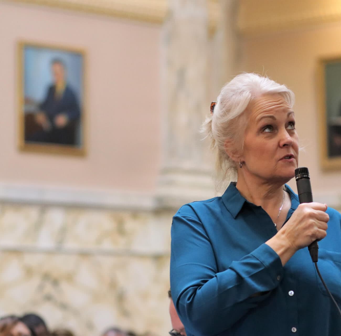 Kathy Szeliga speaking into a microphone on the floor of the Maryland House of Delegates.